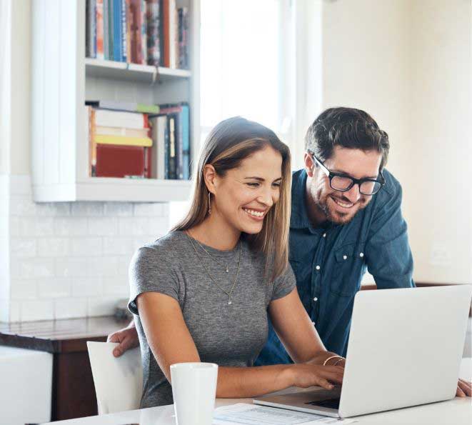 men and women looking at laptop