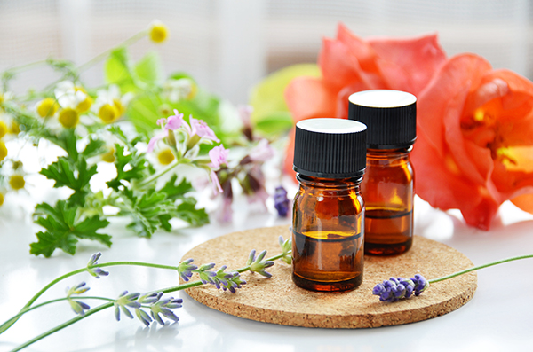 essential oils with herbal flowers for aromatherapy treatment