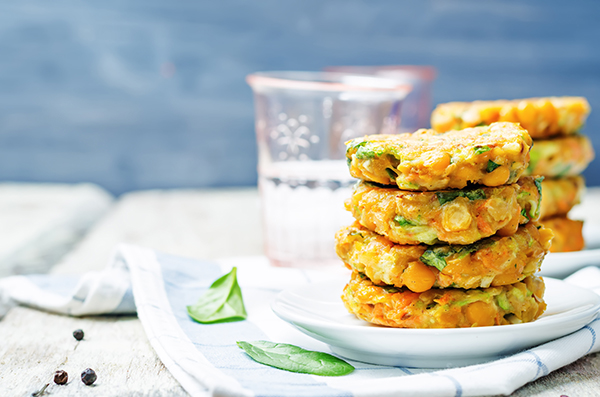 zucchini spinach chickpea burgers on white wood background. toning. selective focus