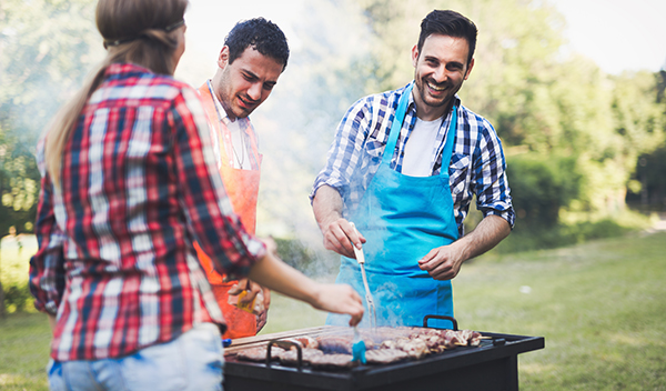 Happy people having camping and having bbq party outdoor
