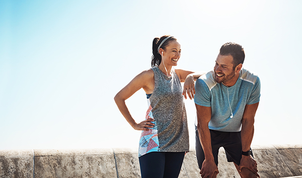 Cropped shot of a young couple out for a run on the promenade