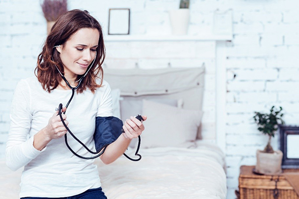 woman taking her own blood pressure