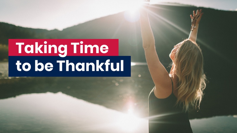 Woman with arms raised in the air being thankful